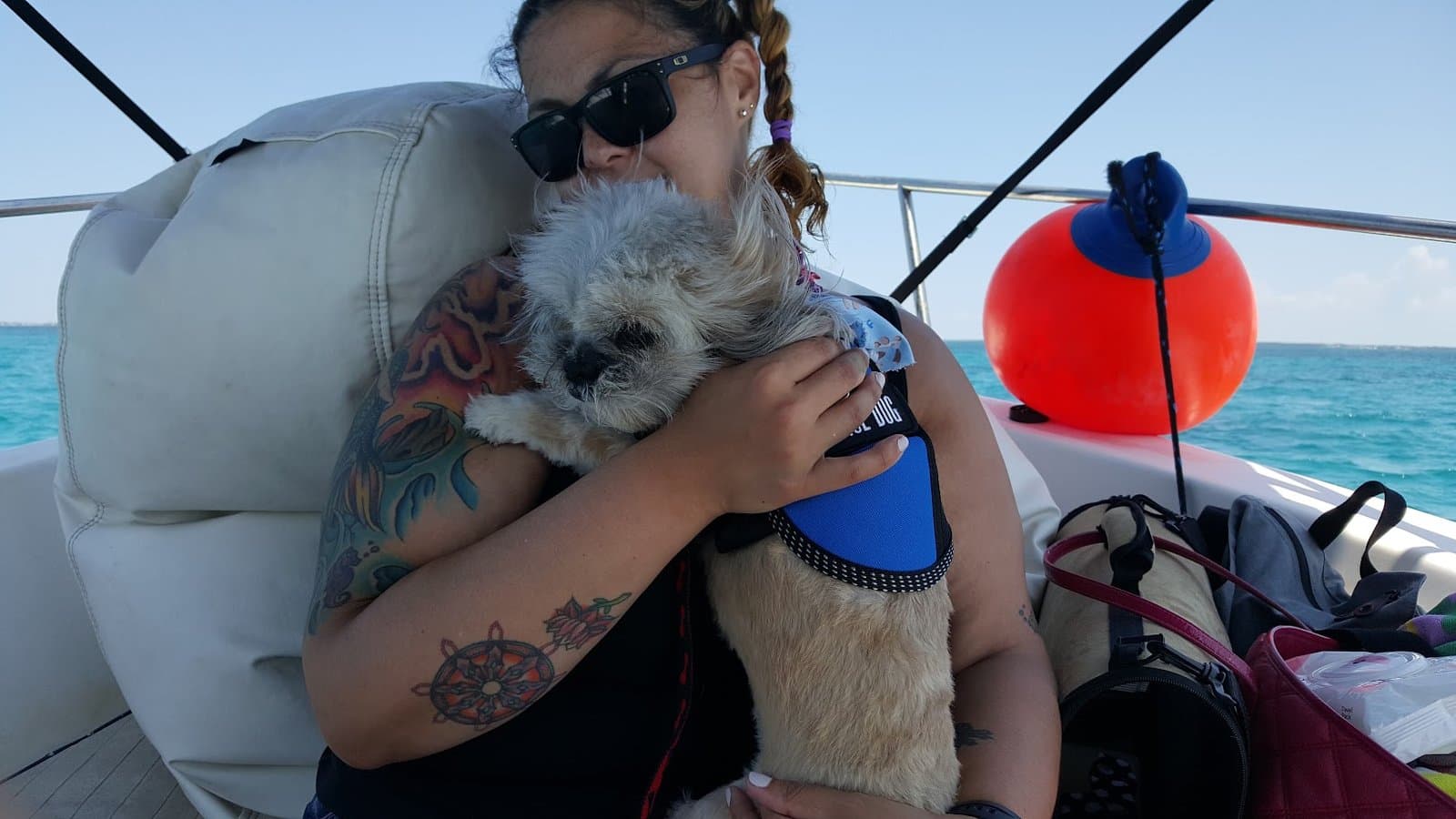 Paris held cheek to cheek with The Other Momma on the boat, open sea behind them