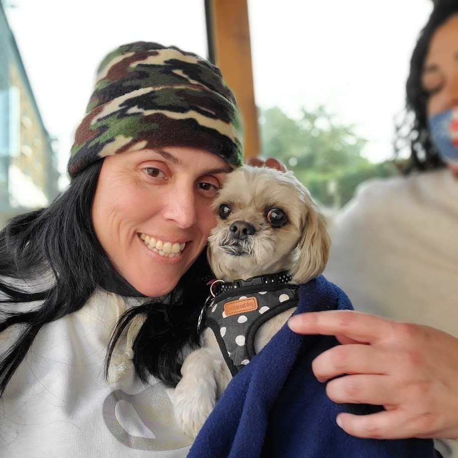 Paris cheek to cheek with Momma in a camo beanie in Savannah